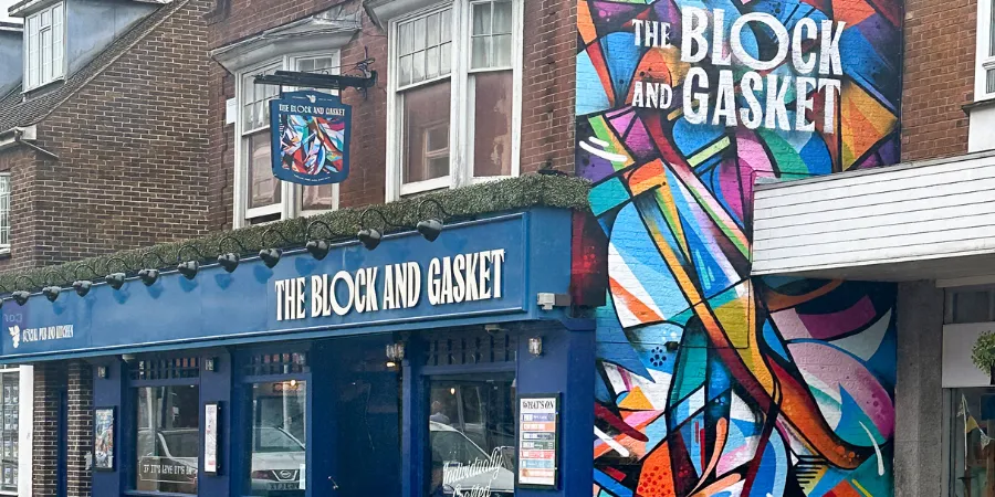 The Block & Gasket shopfront on Church Road, Burgess Hill, with its blue frontage and colourful mural
